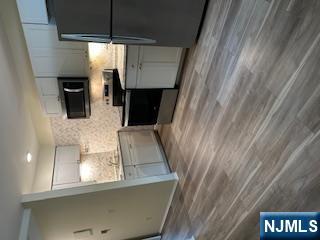 334 Grand Avenue, Unit 10 Leonia, NJ 07605 - Photo 3 of 10 a kitchen with stainless steel appliances a refrigerator and a stove top oven
