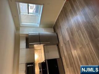 334 Grand Avenue, Unit 10 Leonia, NJ 07605 - Photo 4 of 10 a kitchen with granite countertop a refrigerator and a stove top oven