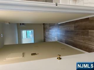334 Grand Avenue, Unit 10 Leonia, NJ 07605 - Photo 5 of 10 a view of a hallway with wooden floor and staircase