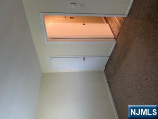 334 Grand Avenue, Unit 10 Leonia, NJ 07605 - Photo 8 of 10 an empty room with a empty space and a window