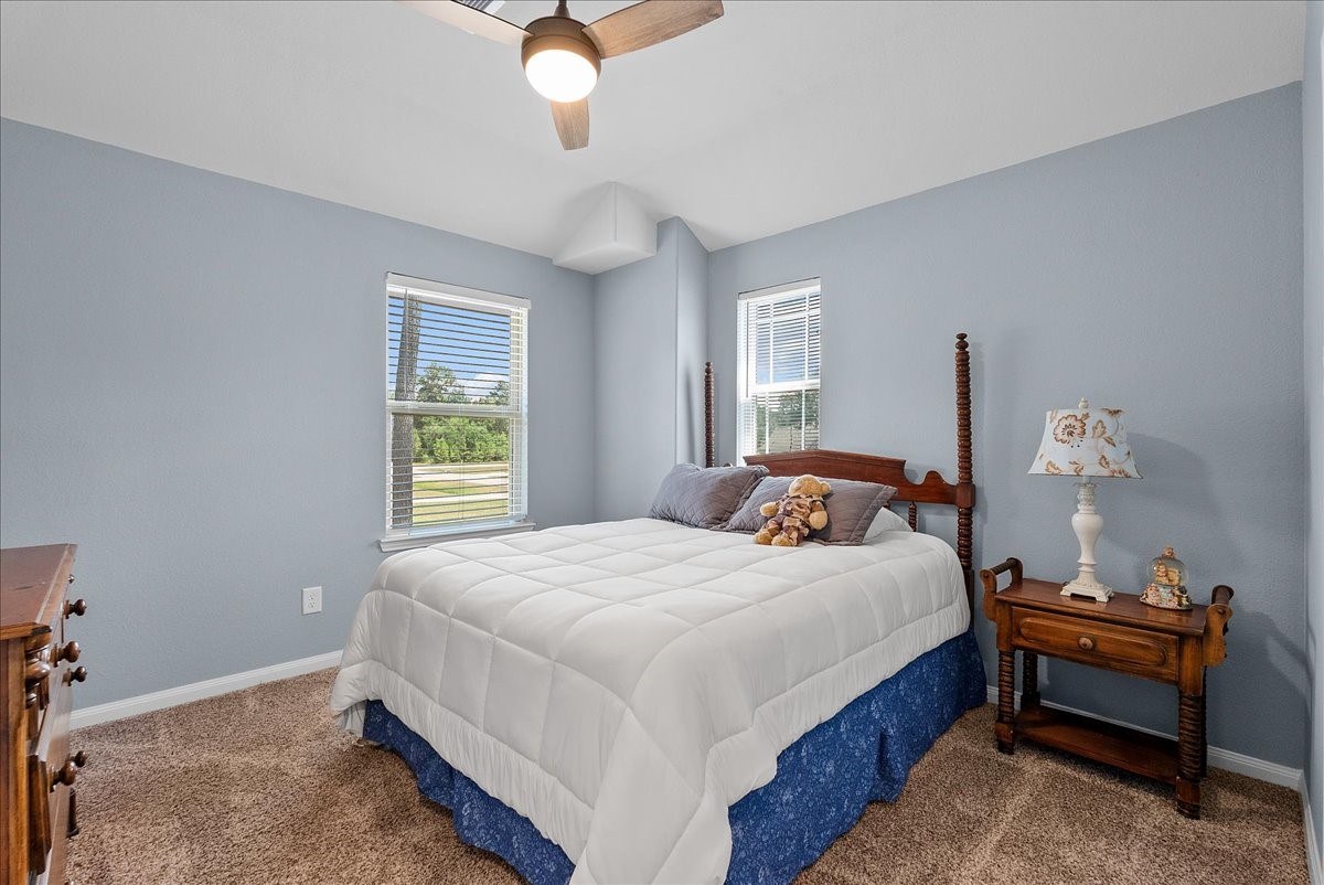 28619 Riverside Crest Lane Huffman, TX 77336 - Photo 30 of 48 Bright secondary bedroom offers comfortable carpet, a ceiling fan and plenty of natural light.