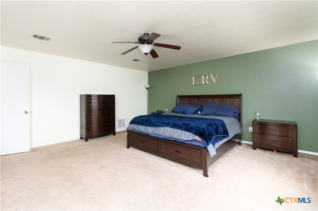 322 Fallen Leaf Lane Temple, TX 76502 - Photo 12 of 26 a bedroom with a bed and a ceiling fan
