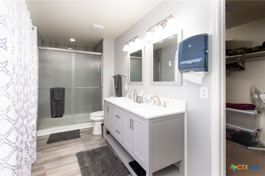 322 Fallen Leaf Lane Temple, TX 76502 - Photo 14 of 26 a bathroom with a sink a toilet and mirror