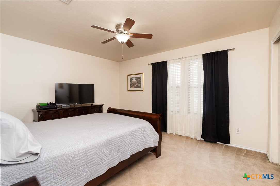 322 Fallen Leaf Lane Temple, TX 76502 - Photo 18 of 26 a bedroom with a bed and a flat screen tv