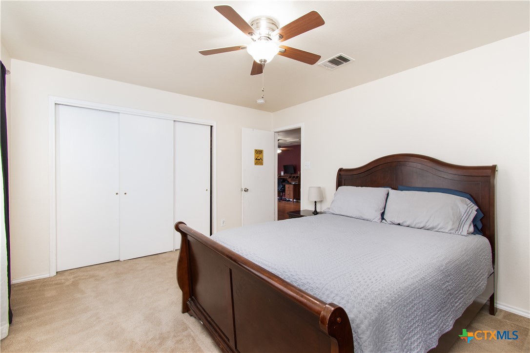 322 Fallen Leaf Lane Temple, TX 76502 - Photo 20 of 26 a bedroom with a bed and a ceiling fan