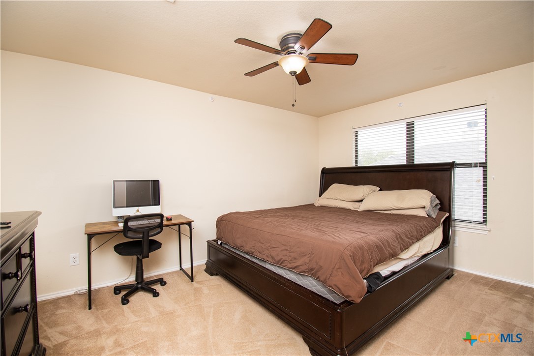 322 Fallen Leaf Lane Temple, TX 76502 - Photo 22 of 26 a bedroom with a bed and a desk
