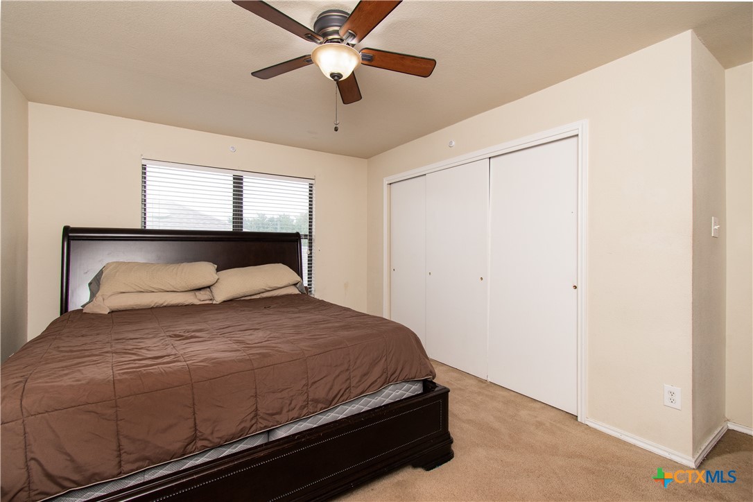 322 Fallen Leaf Lane Temple, TX 76502 - Photo 24 of 26 a bedroom with a bed and a ceiling fan