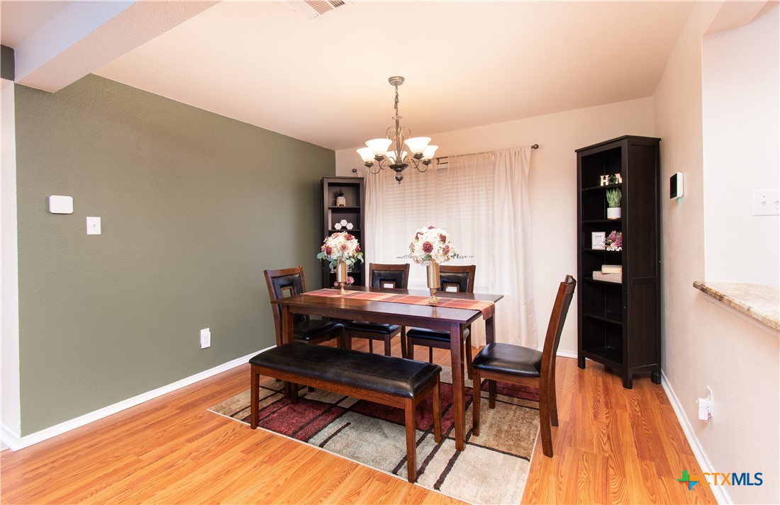 322 Fallen Leaf Lane Temple, TX 76502 - Photo 6 of 26 a view of a dining room with furniture and wooden floor