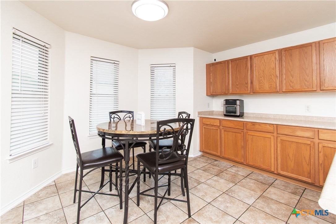 322 Fallen Leaf Lane Temple, TX 76502 - Photo 8 of 26 a view of a kitchen with a dining table and chairs