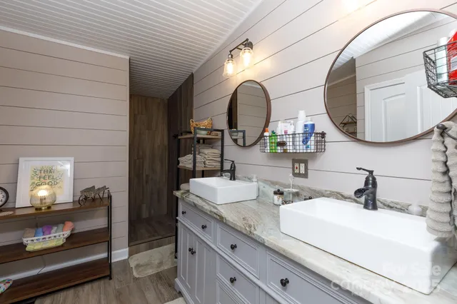 a bathroom with a double vanity sink and a mirror