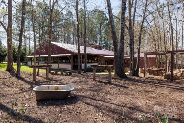 a view of a house with backyard and sitting area