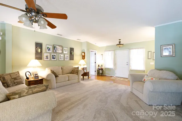 a living room with furniture and a chandelier