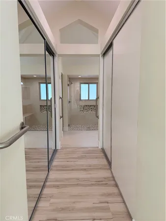 a view of a hallway view with wooden floor and staircase