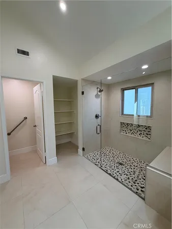 a view of an empty room and a bathroom