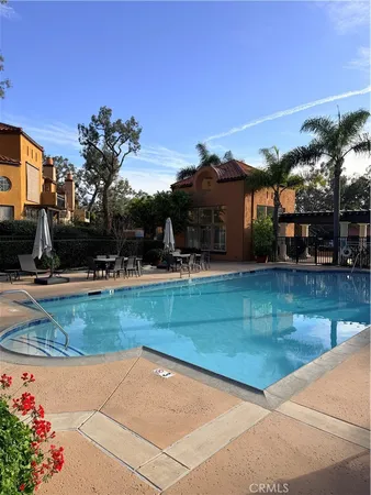 a view of a swimming pool with an outdoor seating and a yard