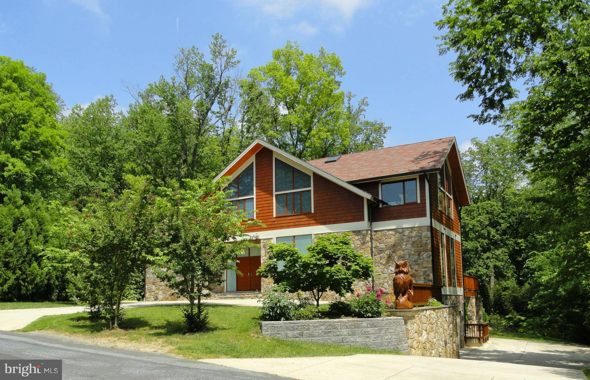 6525 76th Street Cabin John, MD 20818 - Photo 1 of 50 a front view of a house with a yard