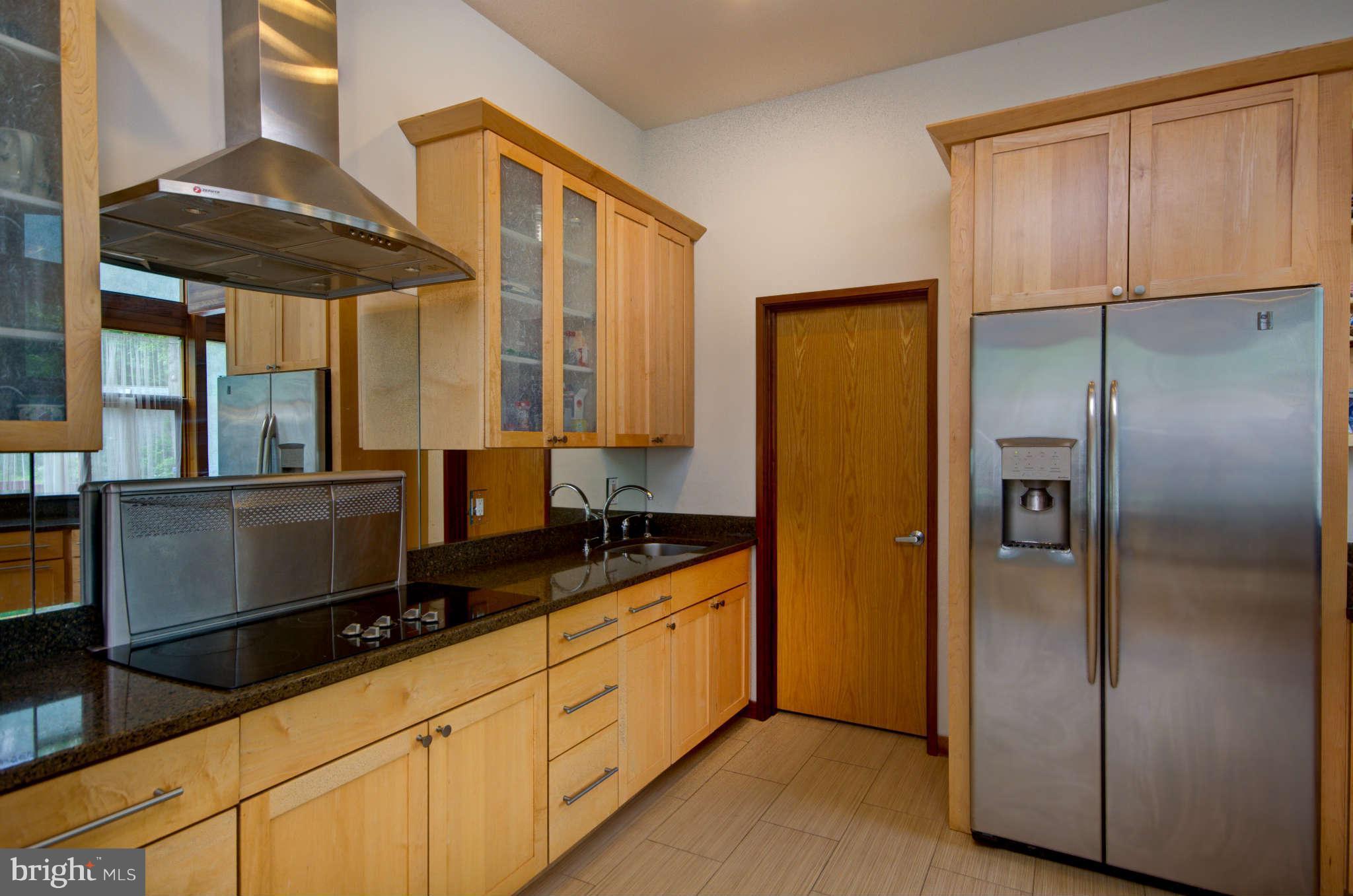 6525 76th Street Cabin John, MD 20818 - Photo 13 of 50 a kitchen with stainless steel appliances granite countertop a refrigerator and a sink