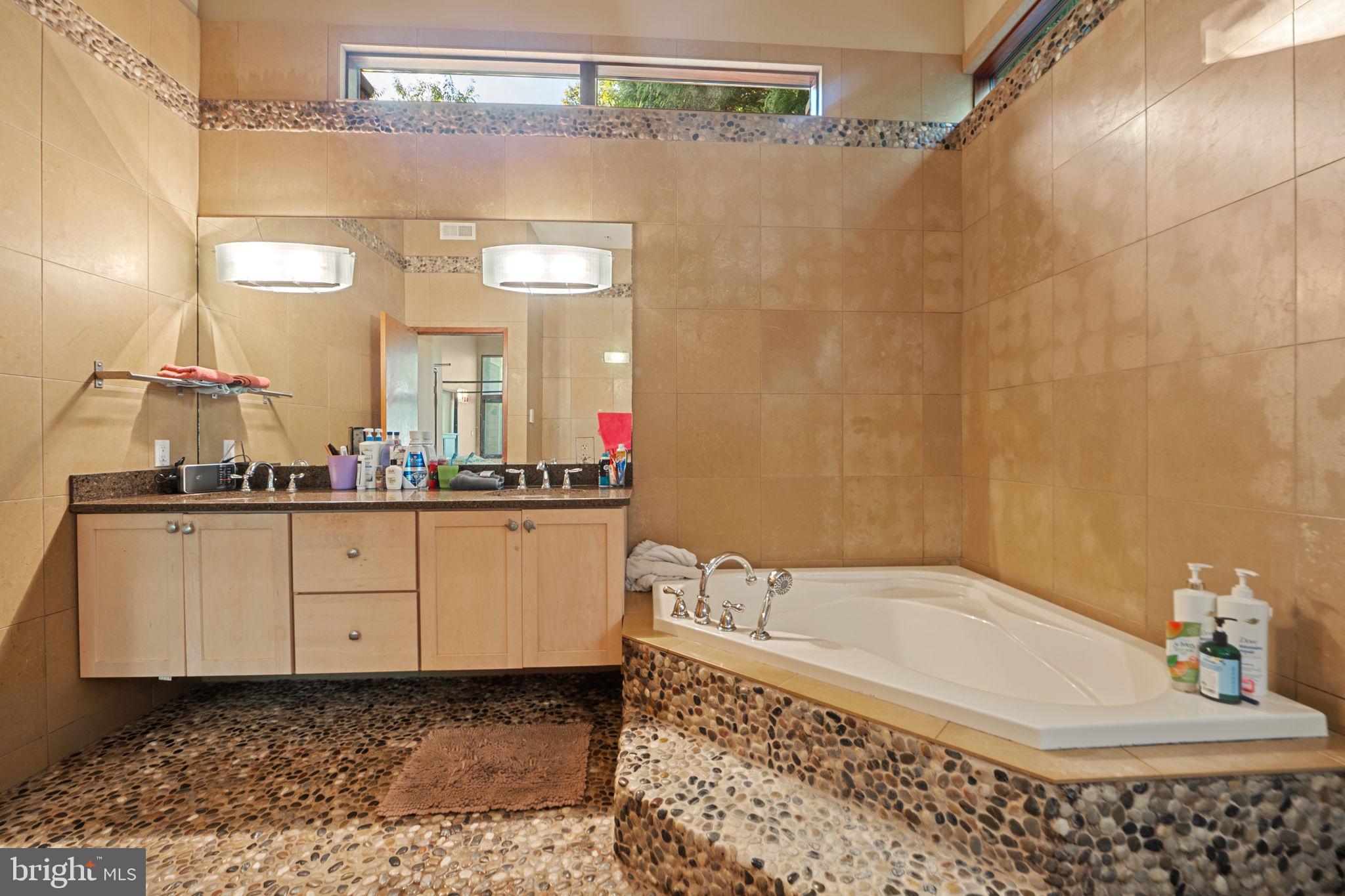 6525 76th Street Cabin John, MD 20818 - Photo 26 of 50 a bathroom with a bathtub and a sink