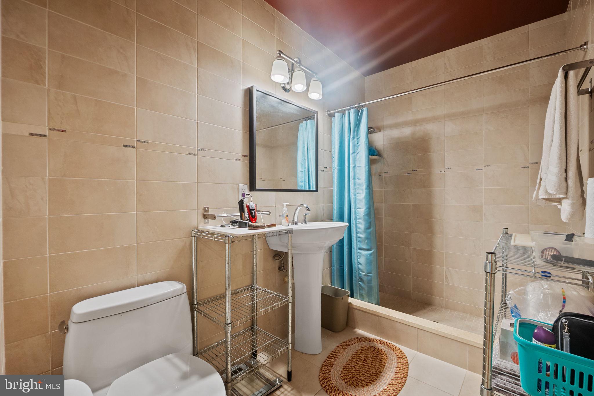 6525 76th Street Cabin John, MD 20818 - Photo 45 of 50 a bathroom with a sink toilet and shower