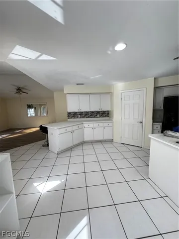a bathroom with a granite countertop toilet sink and mirror