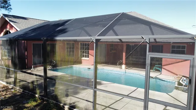 a bathroom with a granite countertop sink a toilet a mirror and shower