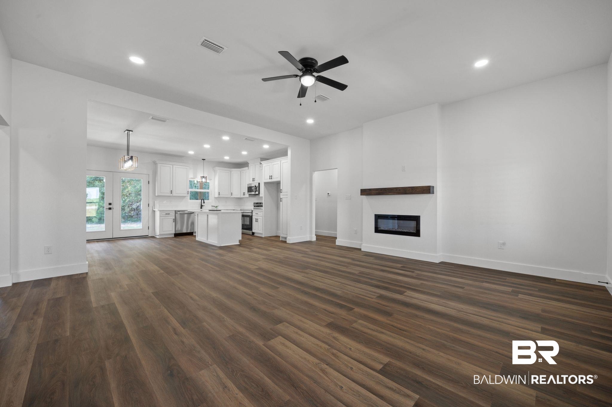 12100 Lott Road Chunchula, AL 36521 - Photo 3 of 21 Unfurnished living room with dark hardwood / wood-style floors, french doors, and ceiling fan