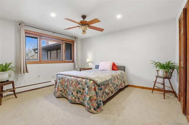 a bedroom with a bed and a potted plant