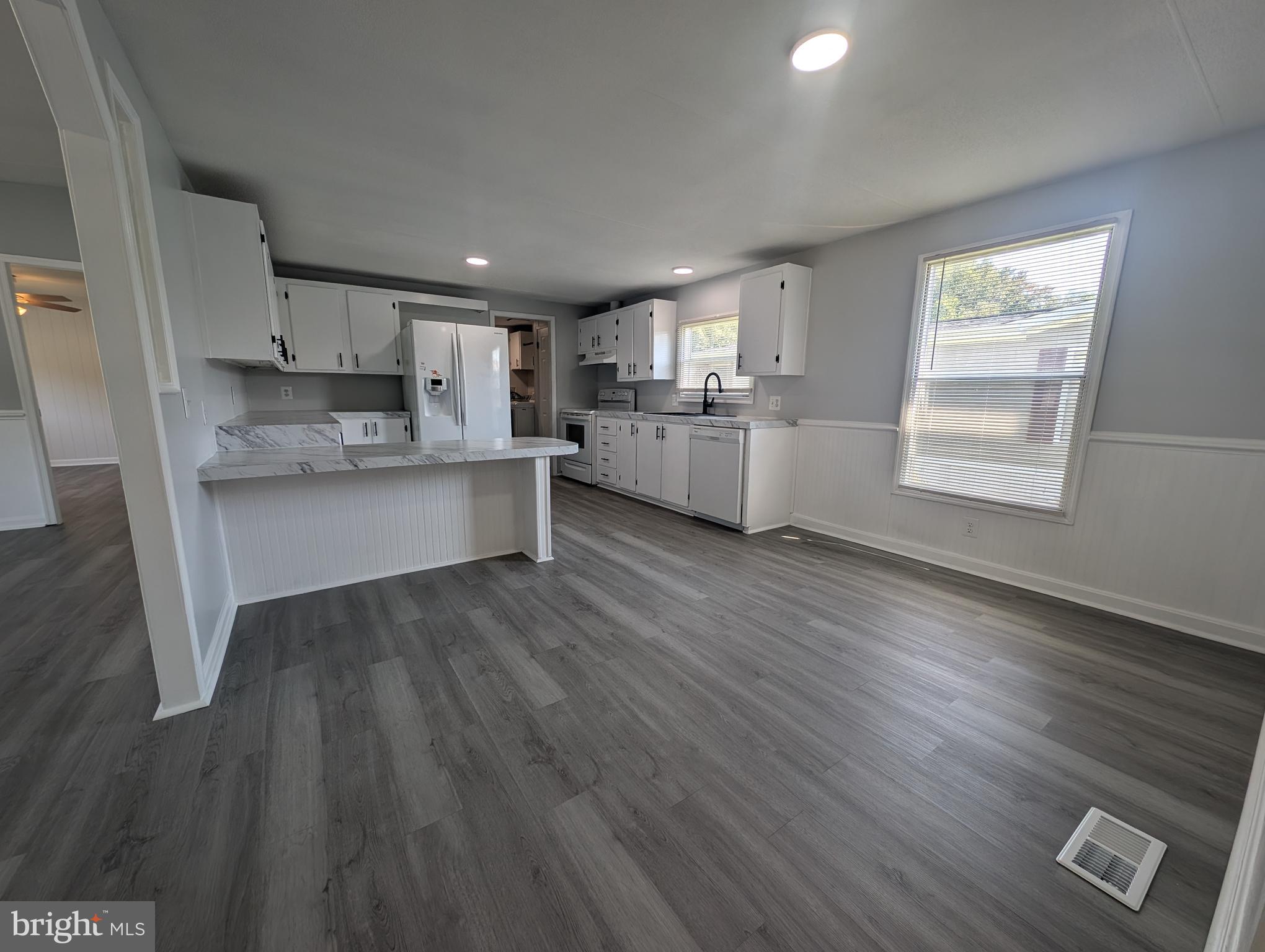 213 Poclain Road Aberdeen, MD 21001 - Photo 2 of 12 a kitchen with stainless steel appliances granite countertop a sink cabinets and wooden floor