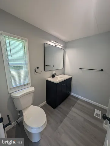 a bathroom with a sink toilet and mirror