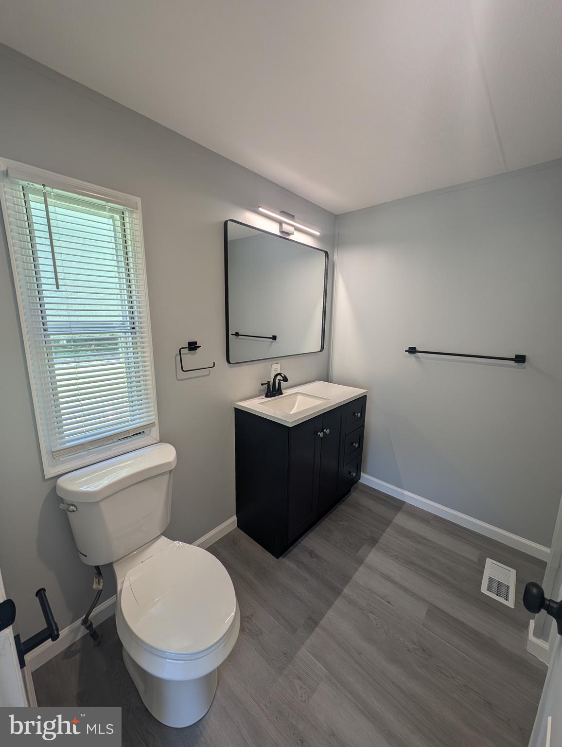 213 Poclain Road Aberdeen, MD 21001 - Photo 5 of 12 a bathroom with a sink toilet and mirror