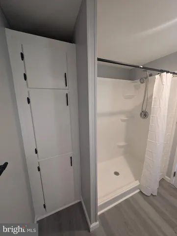 a bathroom with a glass shower door
