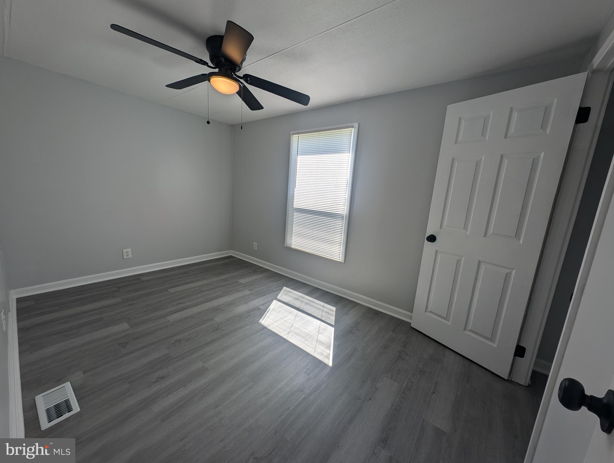 213 Poclain Road Aberdeen, MD 21001 - Photo 8 of 12 wooden floor in an empty room with a window