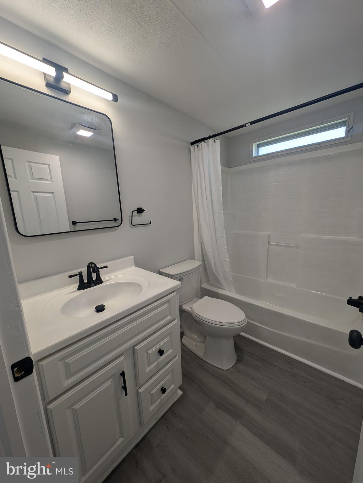 213 Poclain Road Aberdeen, MD 21001 - Photo 9 of 12 a bathroom with a sink a toilet a mirror and shower