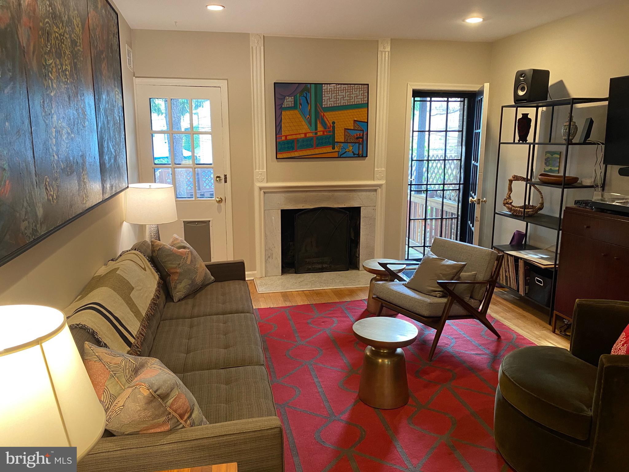 339 11th Street Southeast Washington, DC 20003 - Photo 35 of 39 a living room with furniture a fireplace and a window