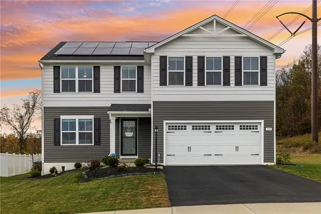 a front view of a house with a yard