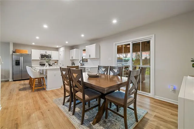 a dining room with furniture and wooden floor