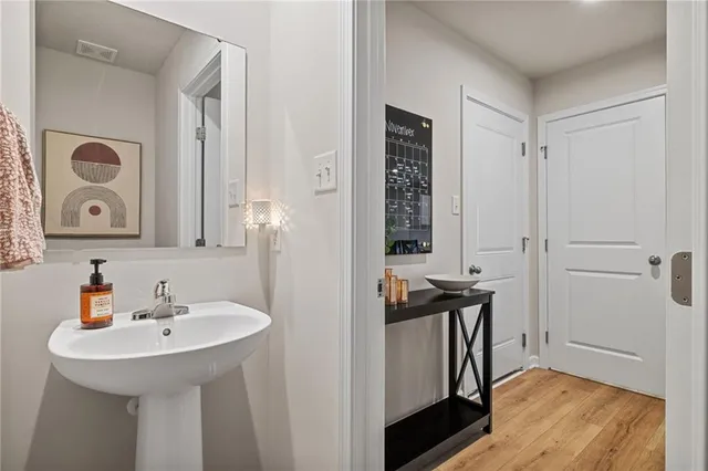 a bathroom with a sink a mirror and a window