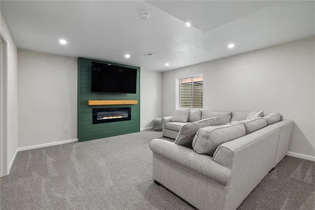 a living room with furniture and a large mirror