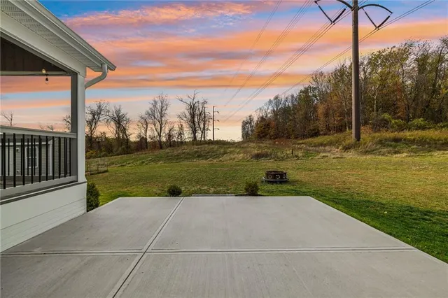 a view of a house with a yard and sitting area