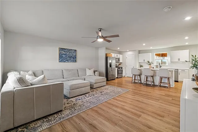 a living room with furniture and wooden floor