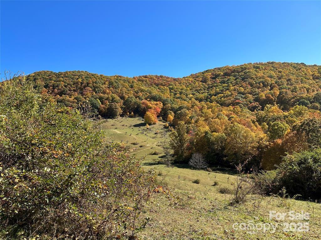 a view of a large mountain with mountains in the background