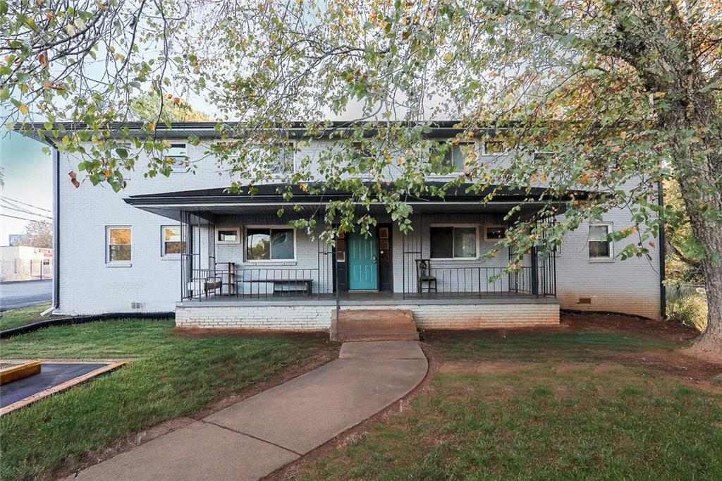 a front view of a house with a garden and plants