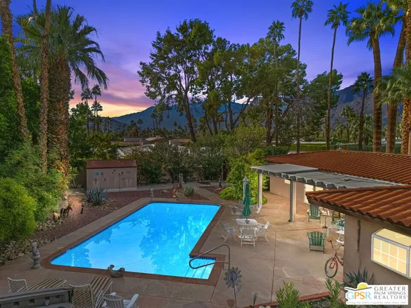 a view of a backyard with swimming pool