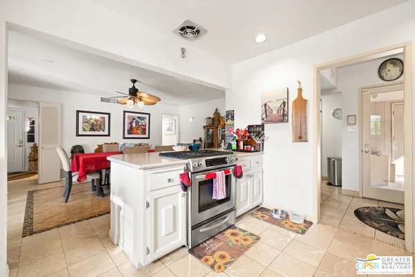 a kitchen with stainless steel appliances kitchen island granite countertop a refrigerator and stove