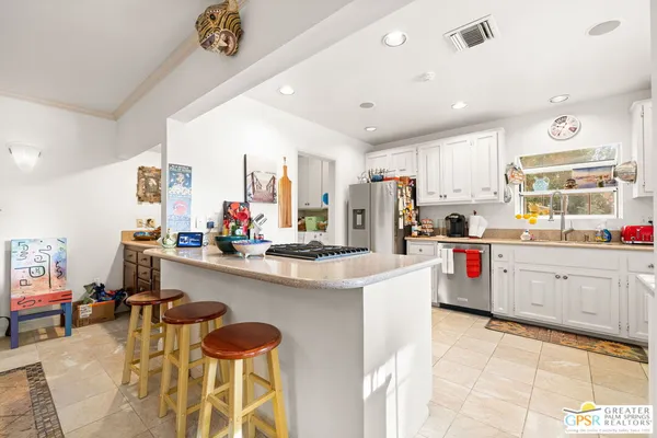 a kitchen with stainless steel appliances kitchen island granite countertop a sink and cabinets