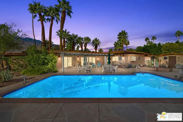 a view of a swimming pool with a house