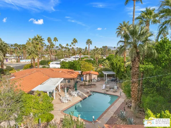 a view of a swimming pool and lounge chairs