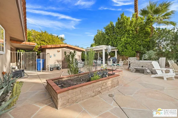 a view of a patio with table and chairs and potted plants