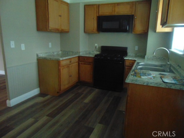 1359 2nd Street Red Bluff, CA 96080 - Photo 3 of 12 a kitchen with stainless steel appliances granite countertop a refrigerator and a stove top oven