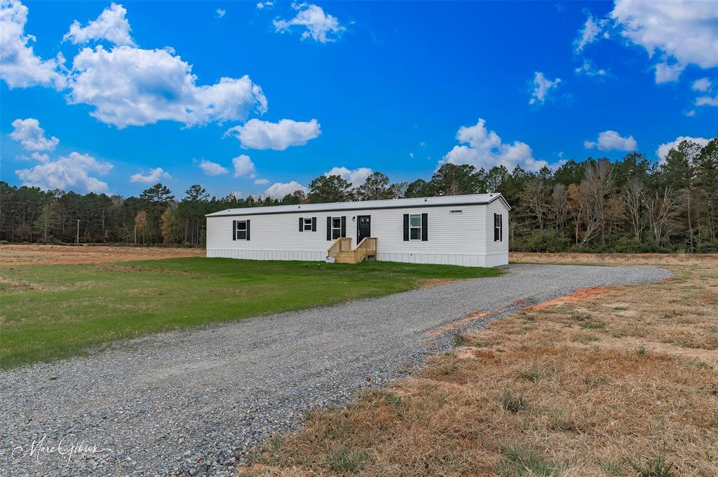 607 Nettleton Drive Princeton, LA 71067 - Photo 14 of 14 a view of a house with backyard and trees